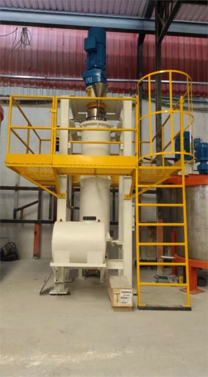 Moinho vertical com plataforma amarela instalado em planta industrial